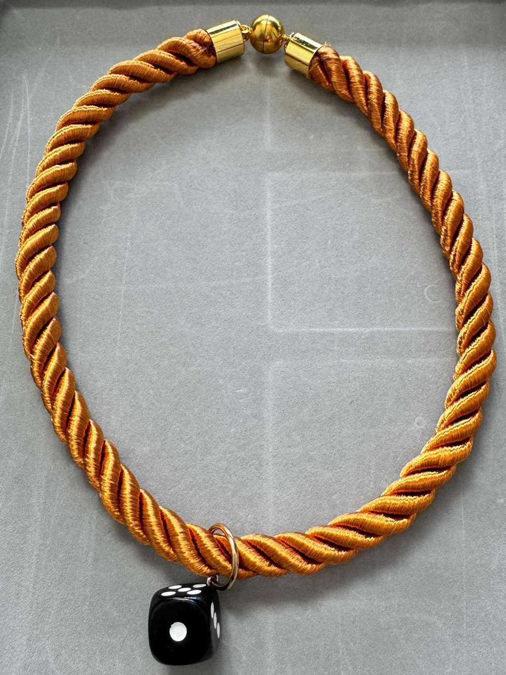 Gold-Tone Twisted Cord Necklace with Black Dice Pendant